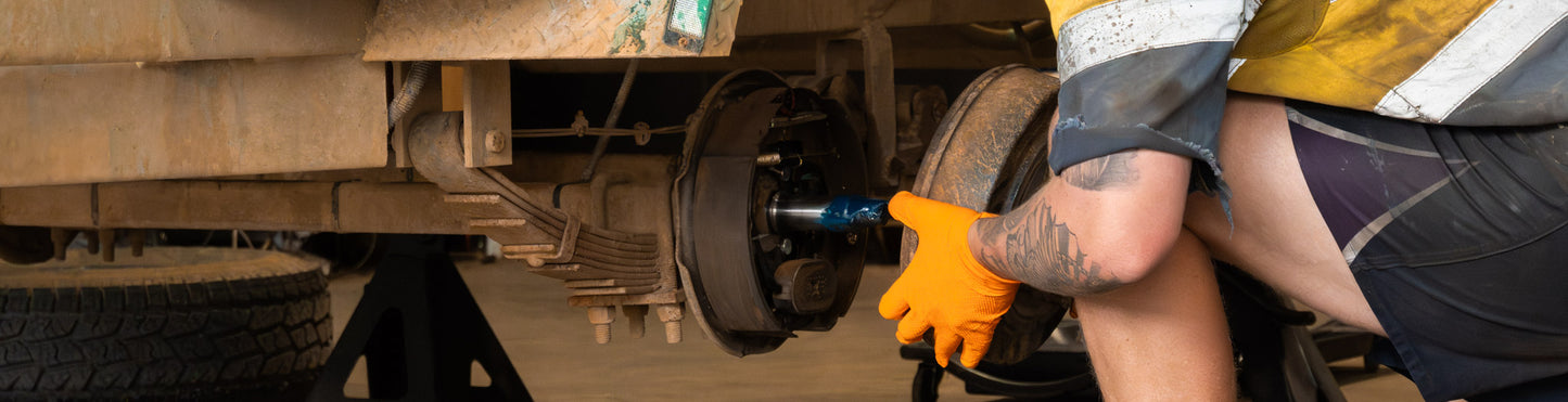 Mechanic Repairing Trailer Hub